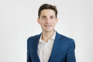 Headshot. Pete in a blue suitcoat with a llight colord button down shirt
